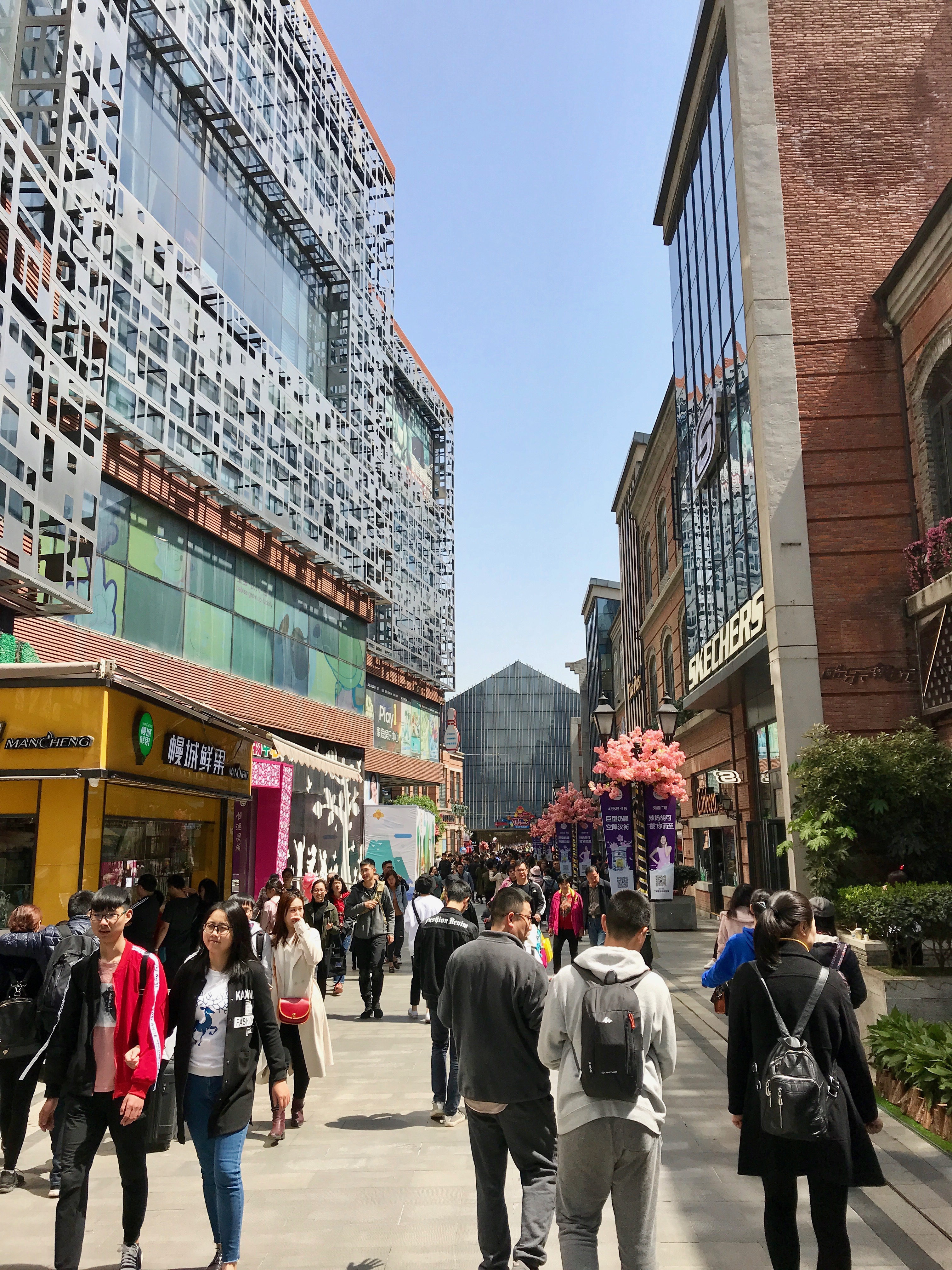 Pedestrians walk past new malls on Han Street (Photo: Carl Hooks)